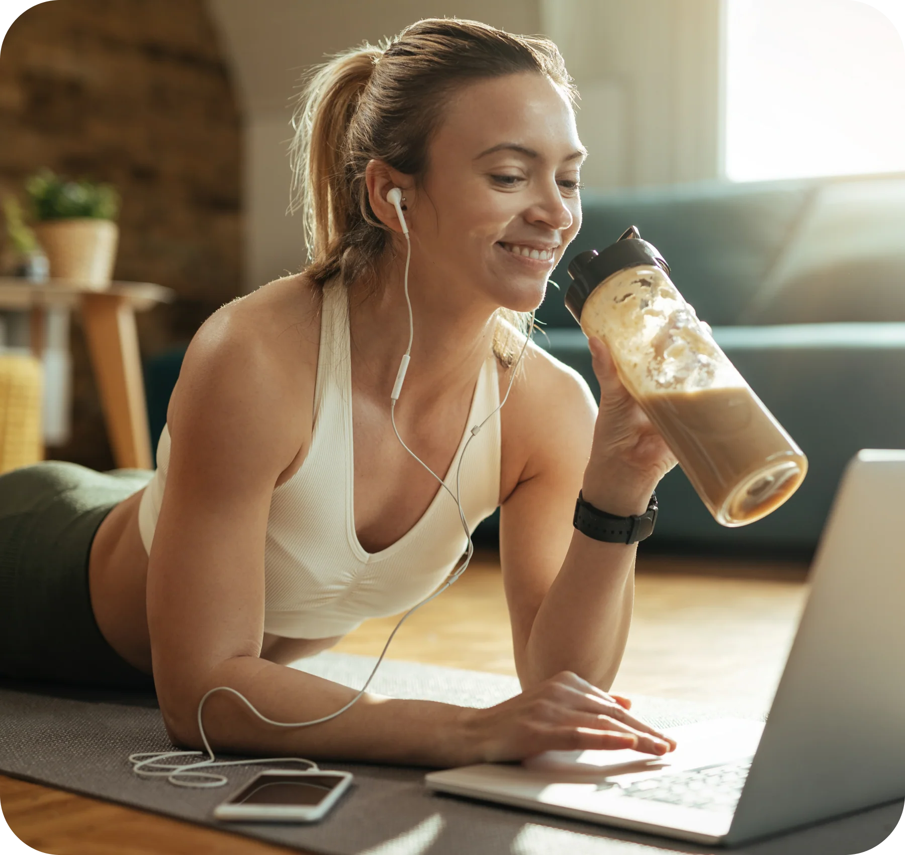Woman enjoying coffee and protein shake while working